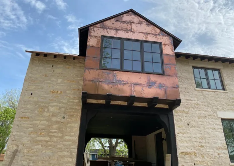 Copper metal panel facade on a stone building for Skylight Installation in Stamford